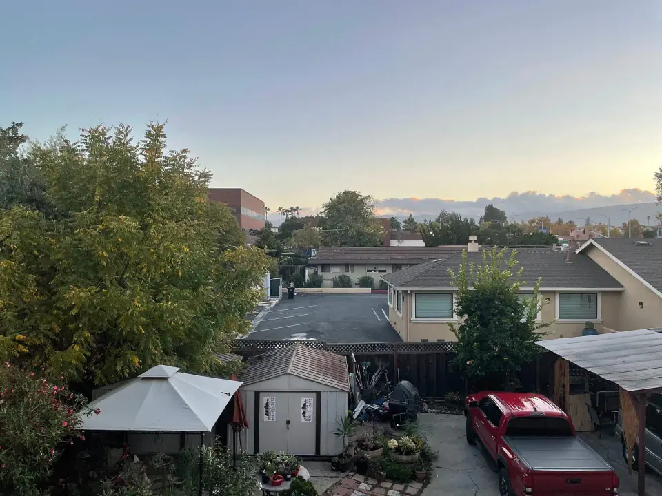 Residential backyards seen from above at sunset.