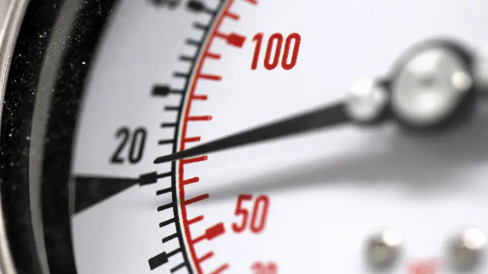 Close view of the dial and needle on a pressure gauge.